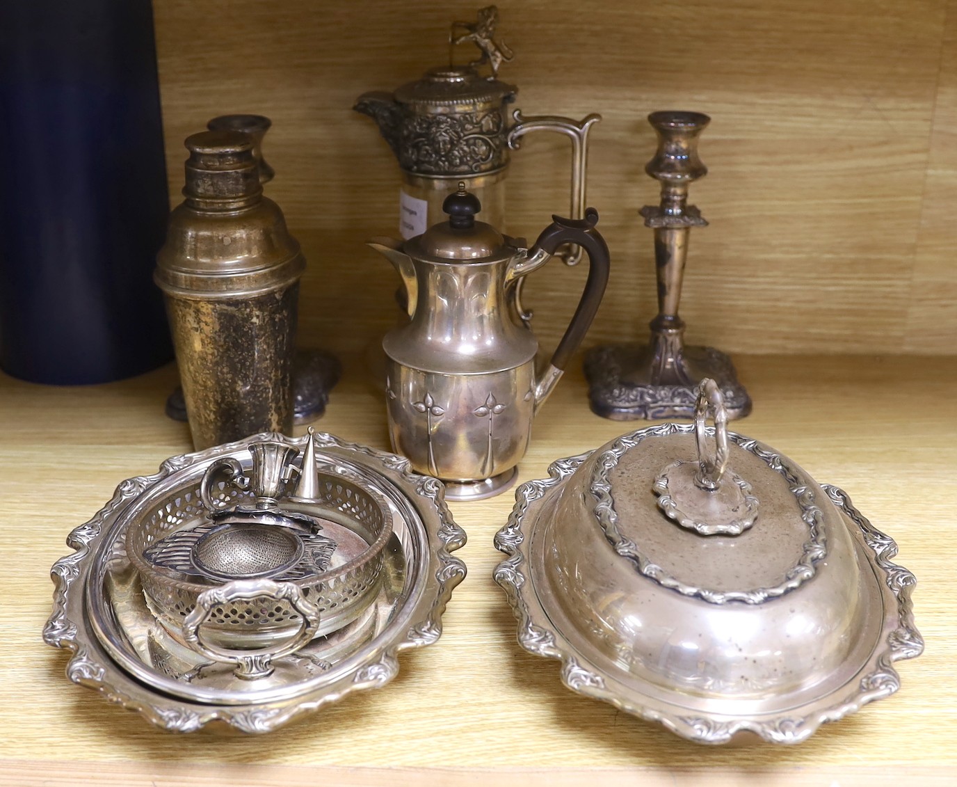 A group of mixed plated wares including tureen, cocktail shaker, claret jug, candlesticks etc.